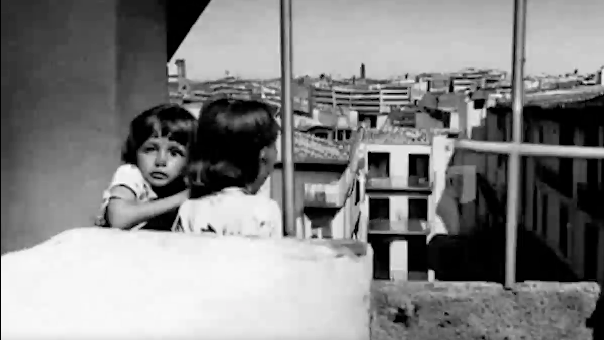 ai generated B&W image of two children looking over a balcony at a city buildings below